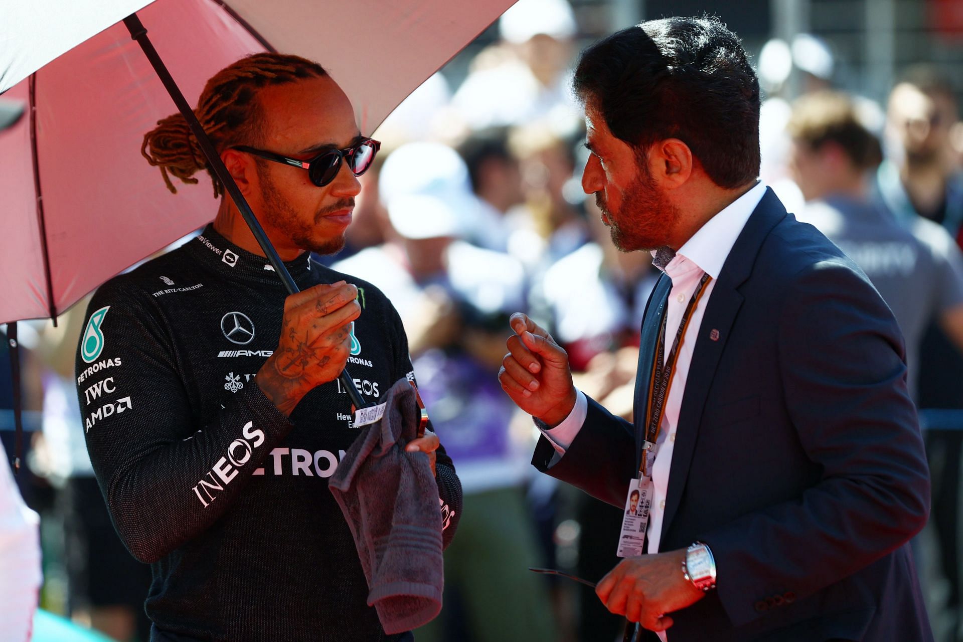 Lewis Hamilton (L) of Great Britain and Mercedes speaks with FIA President Mohammed Ben Sulayem | Getty Images